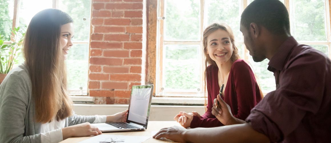 Couple signing a document, possibly related to a real estate transaction or financial agreement.