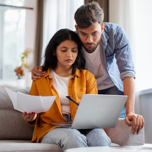 Young couple looking at paperwork,.