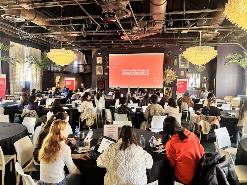 Group surrounding presentation screen.