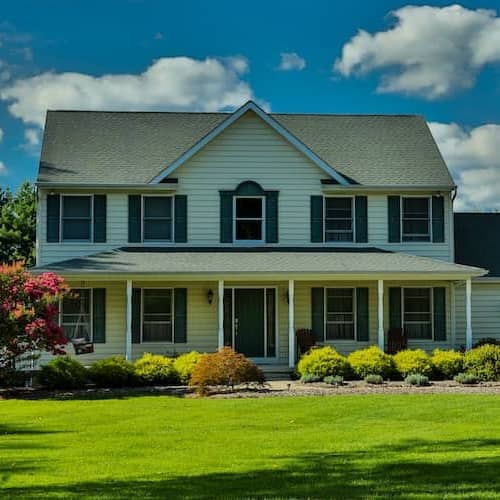 Colonial home with a green lawn.