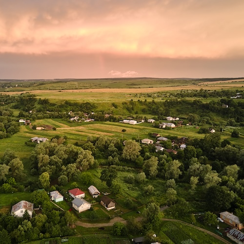 Aerial view of rural homes at sunset.