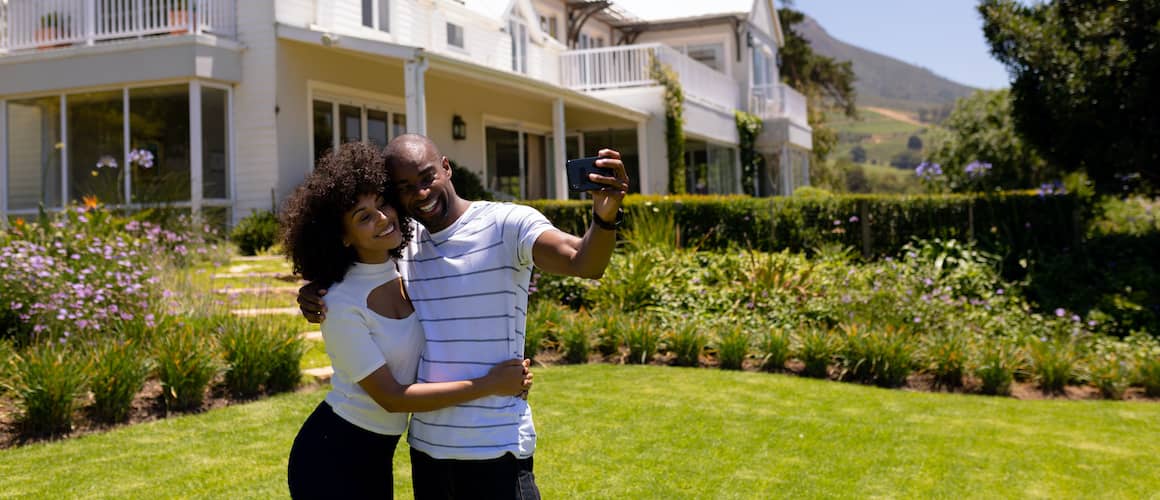 RHB Assets From IGX: Couple taking a selfie in front of their new home