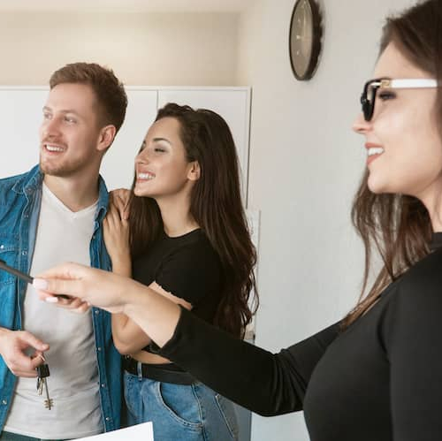 Rental owner showing potential renters around a property, giving a tour of the premises.