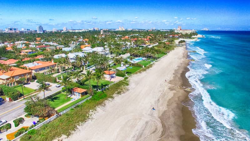 RHB Assets From IGX: Aerial view of Palm Beach, Florida, showcasing the shoreline and ocean.