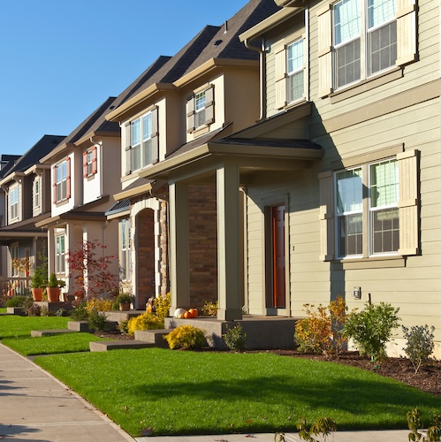 Row of houses on sunny street.