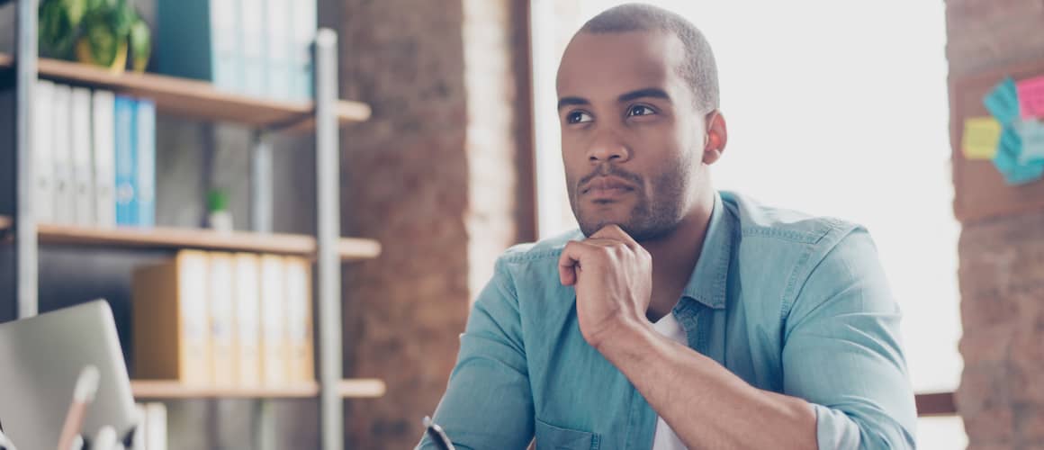 Young student is making decision sitting at the office