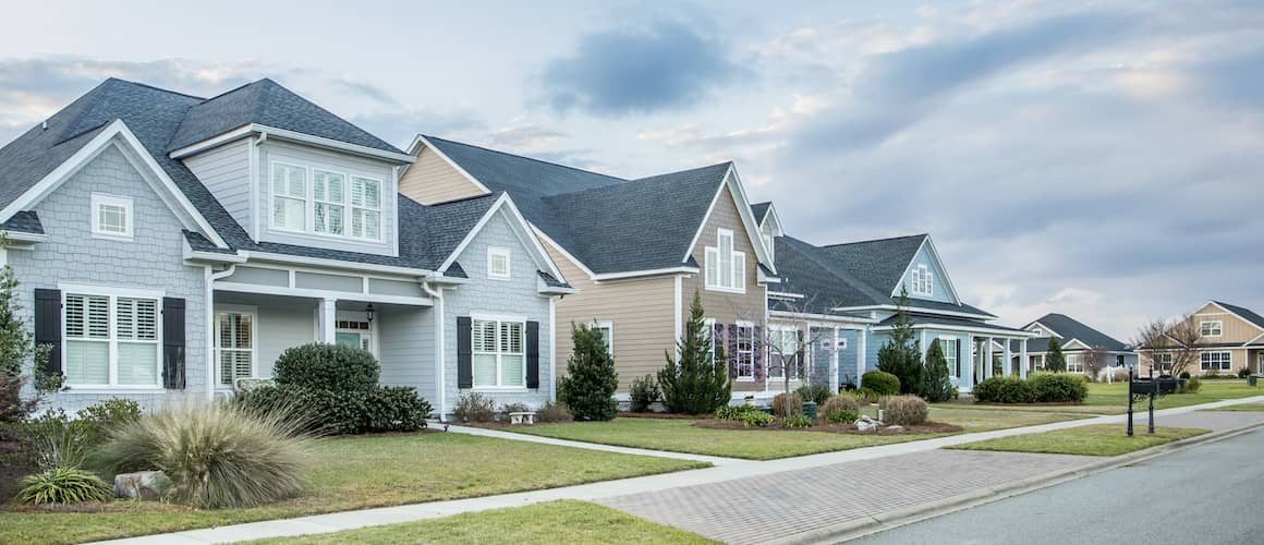 A residential neighborhood with multiple houses, showing a suburban or urban living environment.