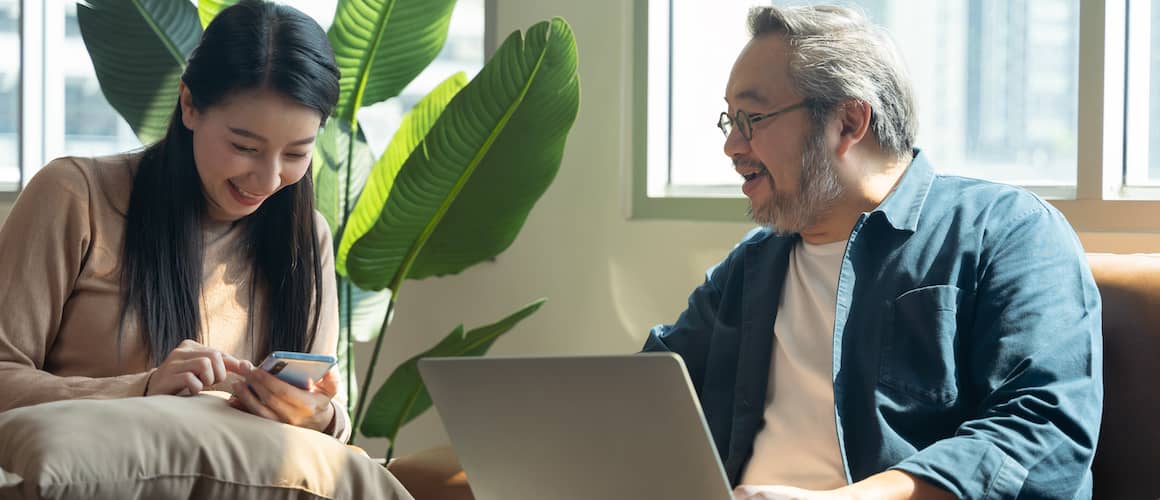 Couple looking at a document and smiling