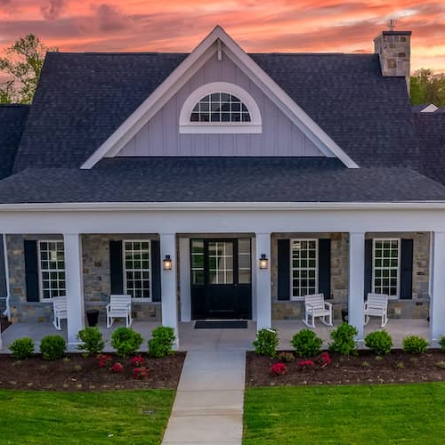 Newly built modern single-family tan home with landscaping, representing construction loans.