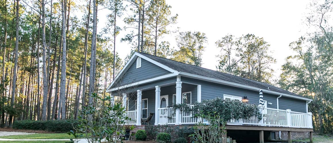 A blue double-wide home, possibly representing a mobile or manufactured house.