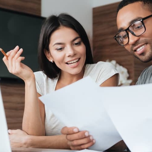 Couple reviewing paperwork together.