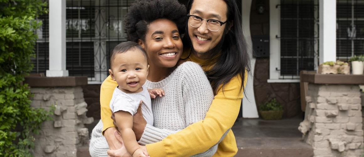 A family in front of a porch, depicting a home setting and family-oriented lifestyle.