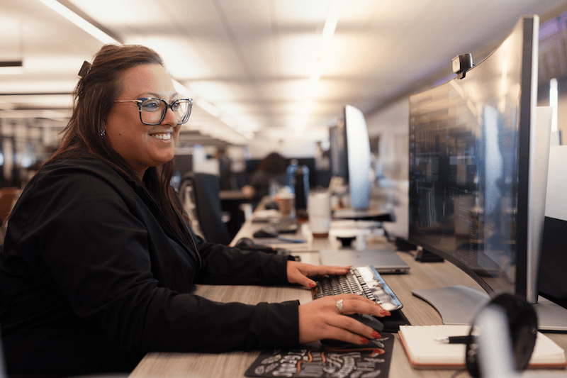 Team member working at her desk.