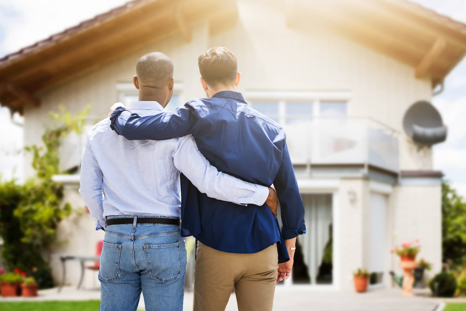 Gay couple infront of a dream house 