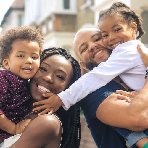 Image depicting a black family of four, possibly emphasizing diversity or representation.
