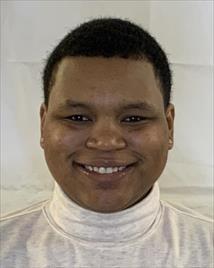 Headshot of a woman smiling against a white background.