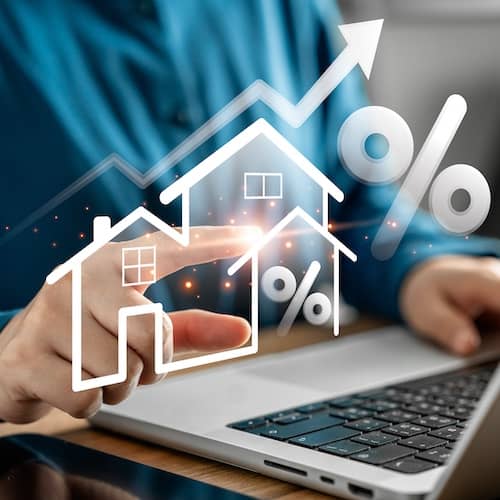 Individual pointing at virtual home overlaying the base of a laptop.