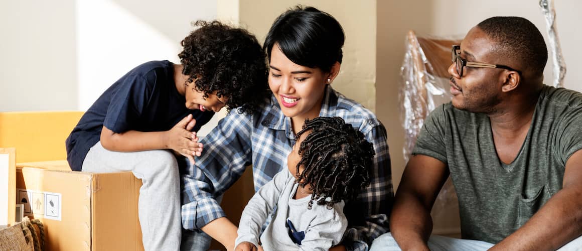 A Black family involved in the process of moving into a new house, indicating relocation or settling.