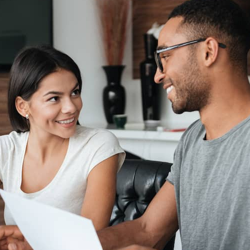 An image showing a couple discussing finances, possibly related to financial planning or discussions.
