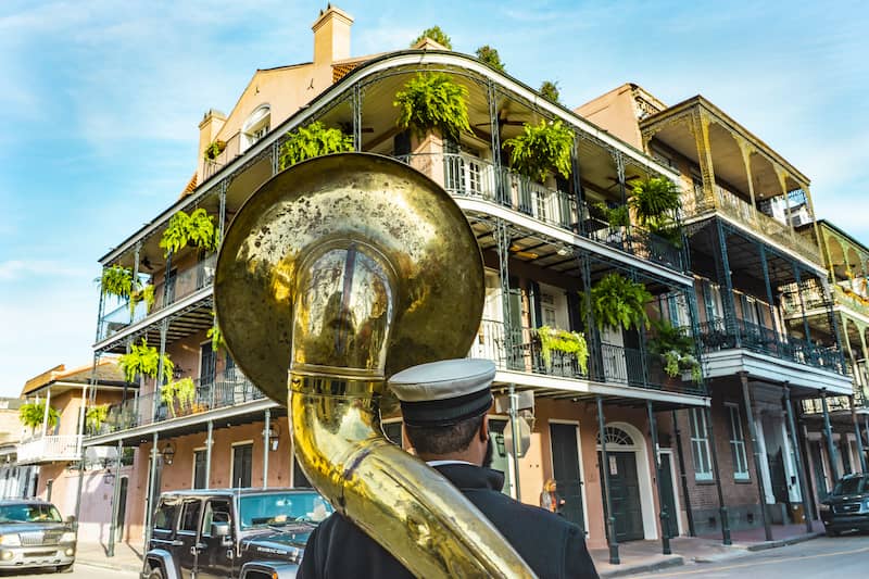 RHB Assets From IGX: New Orleans street scene with musicians playing instruments.