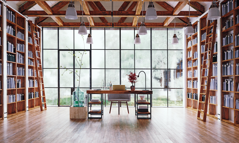 Floor-to-ceiling bookshelves in bright library.