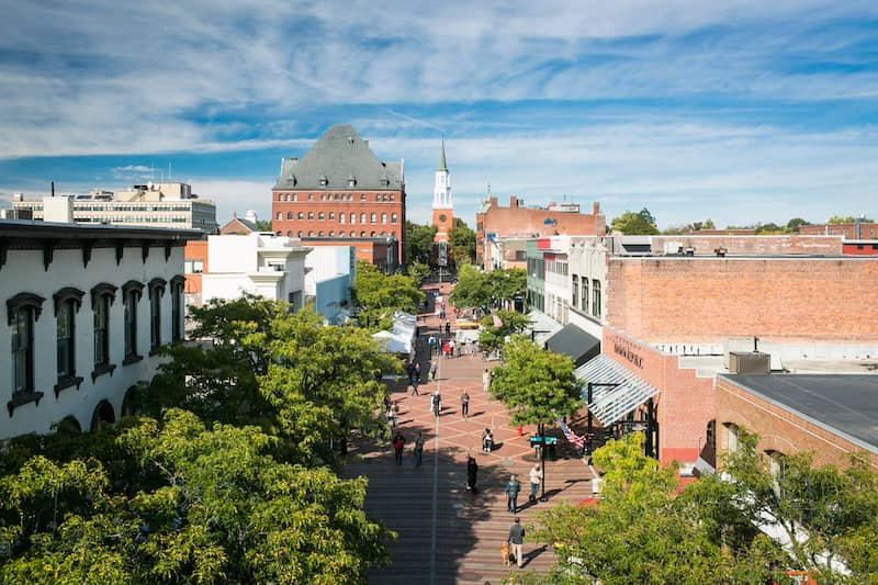 RHB Assets From IGX: A high-angle view of Church Street in Burlington, Vermont, with brick buildings and cherry blossom trees.