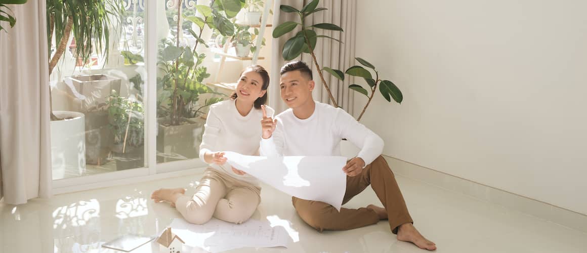 A couple checking layout of their house.