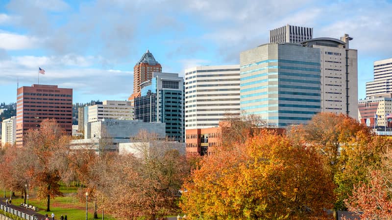 RHB Assets From IGX: A scenic view of Portland, Oregon in fall, with colorful foliage and a cityscape backdrop.