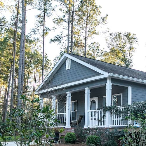 A blue double-wide home, possibly representing a mobile or manufactured house.