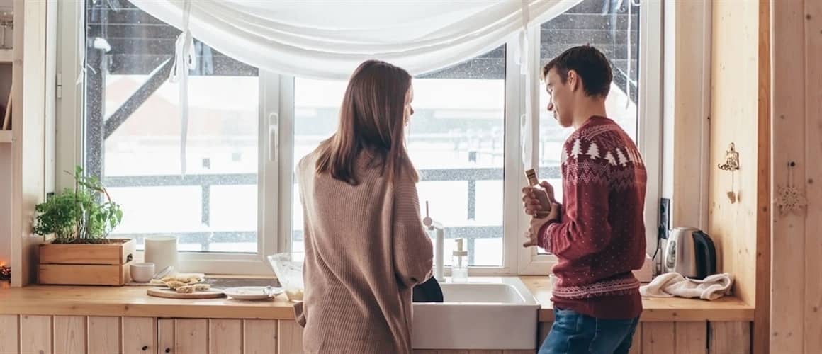 Image of couple discussing home improvement ideas in kitchen.