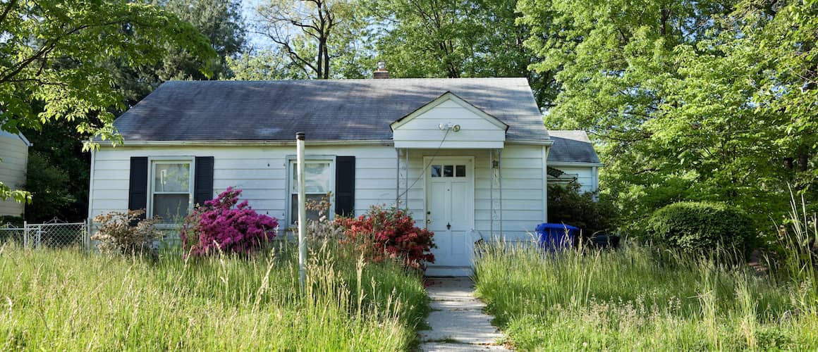 A white house with a front yard.