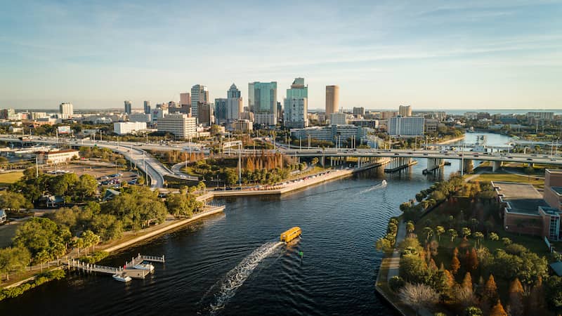 RHB Assets From IGX: A panoramic view of downtown Tampa, Florida with tall buildings, blue sky and white clouds.