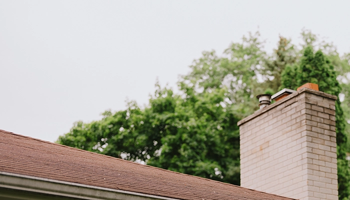 Small light grey home with porch light.