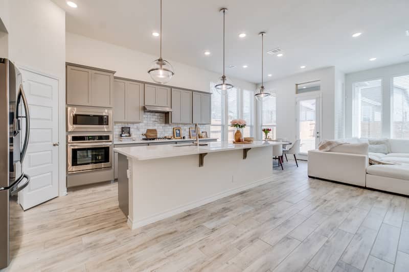 Open concept white kitchen in a condo.