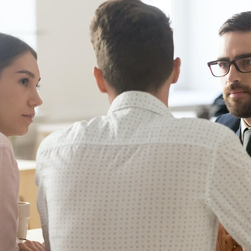 A young couple breaking up with a realtor, possibly indicating a change in their home search or real estate plans.