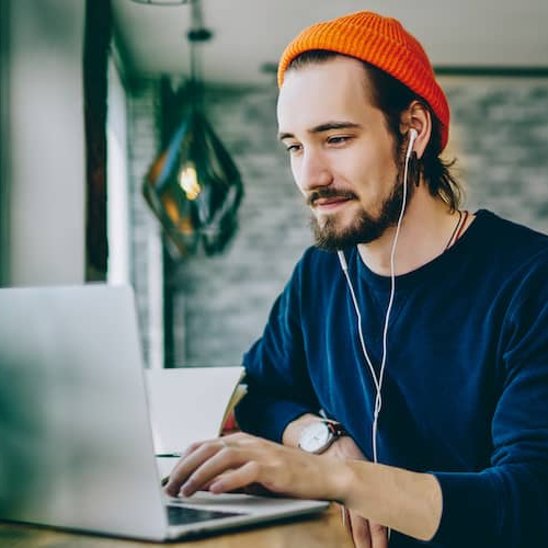 Man on laptop in cafe.