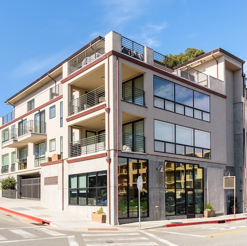 Apartment building with what appears to be a gym or store in the first floor.