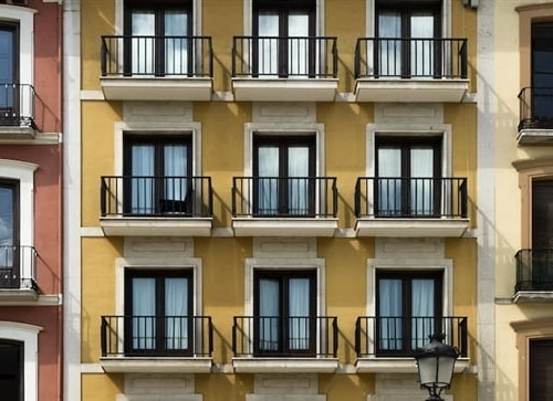 Image showing vibrant buildings with balconies in a row possibly indicating good investment opportunities.