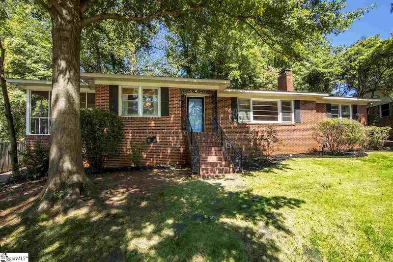 RHB Assets From IGX: A charming Greenville house with a welcoming front porch and beautiful landscaping.