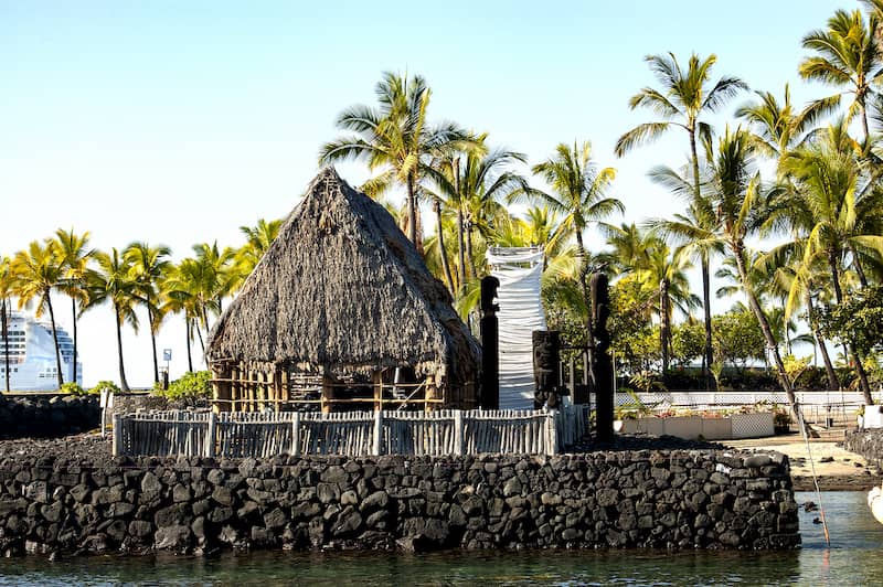 RHB Assets From IGX: A beautiful coastal view of Kailua-Kona, Hawaii with palm trees and blue waters.