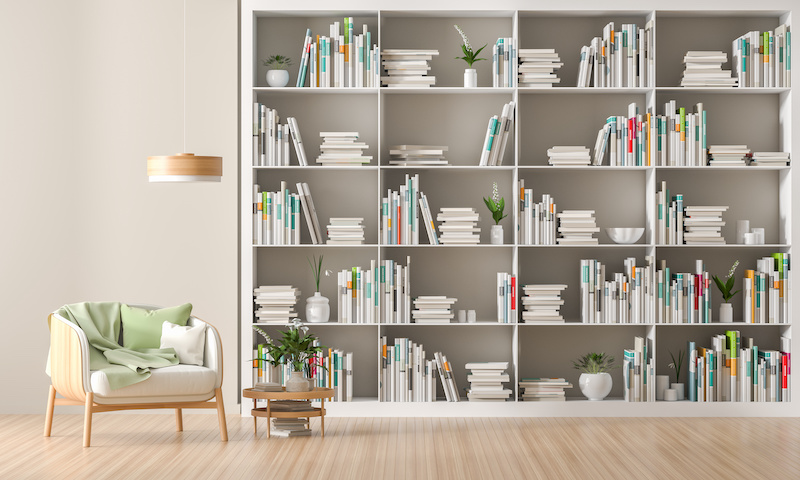 Modern, Scandinavian style interior with book shelf full of books. Minimalist interior design. 