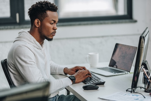 Young man working at desk in office.