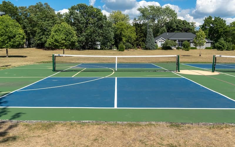 Pickleball court with a homes in the background. 