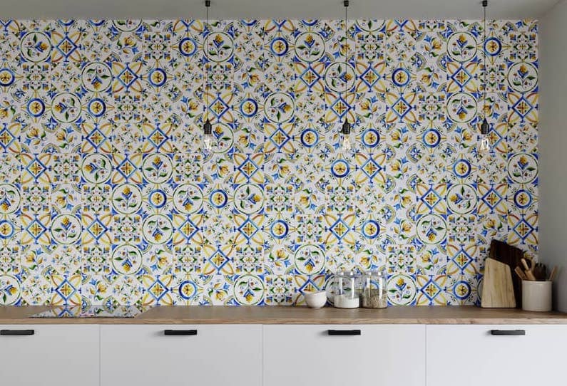 Custom colorful classic mosaic tile backsplash that goes up to the ceiling.