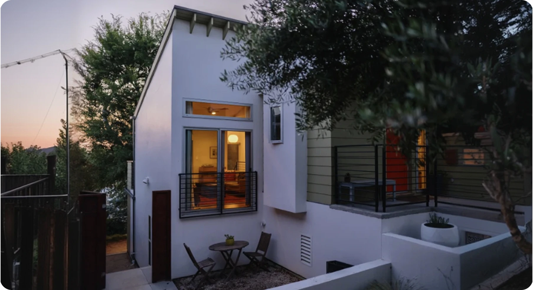 Modern home with outdoor patio at dusk.