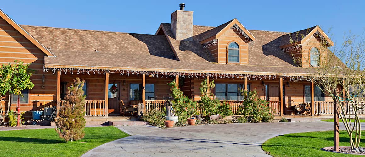 The entrance to a brown ranch-style home, depicting a property's entrance or exterior.