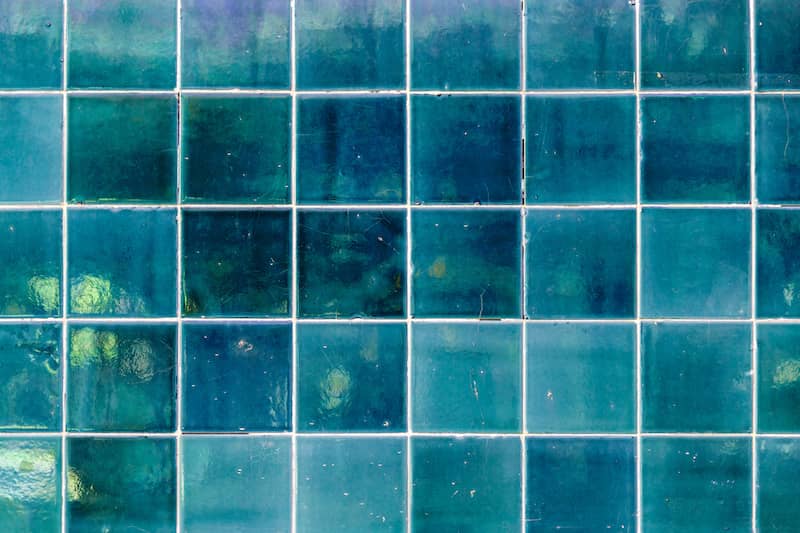 Blue green glazed ceramic square tiles for backsplash.