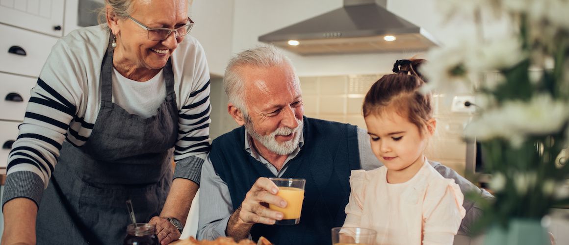 Grandparents enjoying breakfast together, portraying family moments in a home setting.