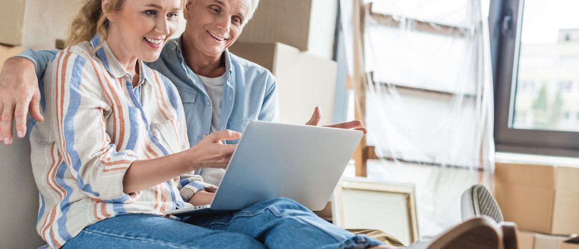 Image of couple reviewing loan in new home.