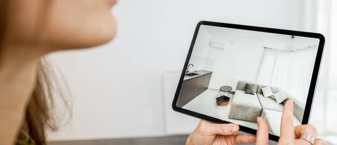 RHB Assets From IGX: Woman using augmented reality on a tablet to view a virtual real estate property